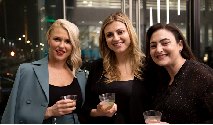 Drs. Alterman and Yugelson pose with a third woman at the new office's grand opening. Dressed up, celebratory, smiling.